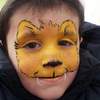 a watermarked face painting lion cub