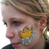 a watermarked face painting easter chick and flowers