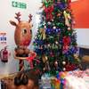 a balloon watermarked reindeer stood beside a christmas tree